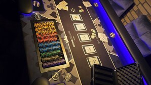 A casino table with poker chips, cards, and a dealer button.