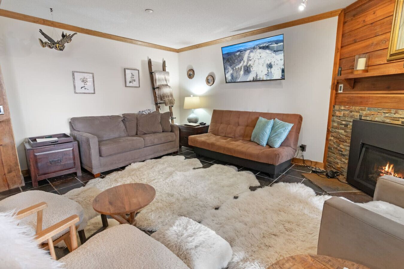 A cozy living room with a fireplace, a sofa, a coffee table, and a rug.