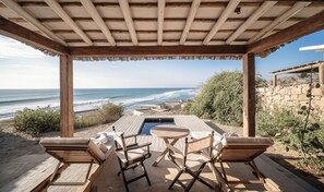 A wooden deck with a pool, overlooking a beach and ocean. - Inkaterra Cabo Blanco (El Alto)
