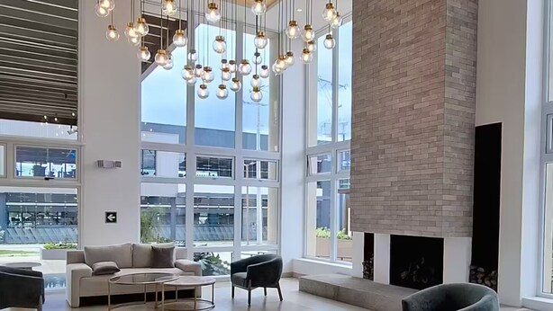 A modern living room with a large white sofa, a round coffee table, and a fireplace. - Glam | Modern apartment in exclusive area of Xela (Quetzaltenango)