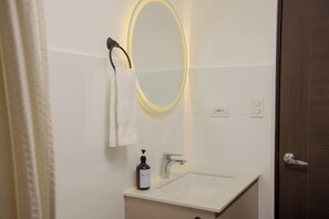 Een douche, handdoeken, zeep, toiletpapier