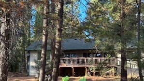 A two-story house with a wooden deck and a satellite dish. - Adventure Retreat - Sunriver/Bachelor/Waterfront (Bend)