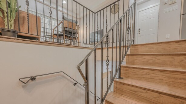 A wooden staircase with metal railings and a handrail. - Perfect Traveling Nurse Housing - Theatre District (Boston)