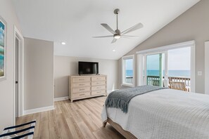 A bedroom with a bed, a dresser, a ceiling fan, and a TV. - Do Knot Disturb Oceanfront Private Pool Renovated Sleeps 14 (Emerald Isle)