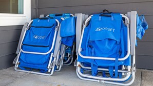 Deux scooters électriques bleus, portant la marque « Ocean », sont garés contre un bâtiment dont le revêtement extérieur est gris.