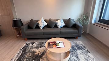 Deluxe Studio Suite, Canal View | Living area | TV, toys