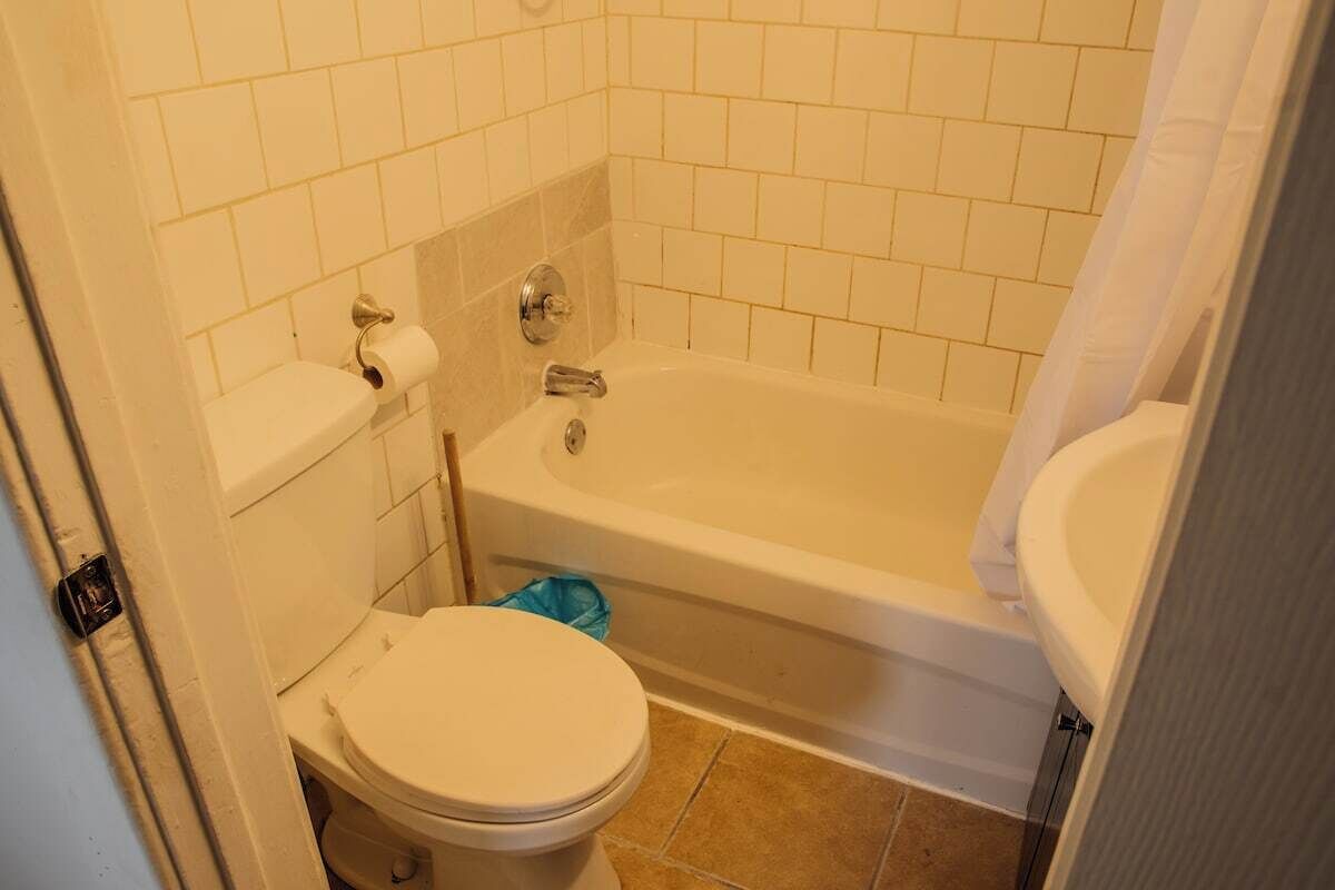 A bathroom with a toilet, a bathtub, and a sink.