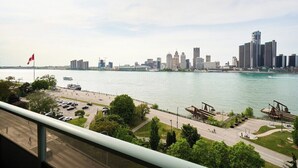 A city skyline with modern buildings, a river, and a bridge. - 902 - Stylish Waterfront Executive Condo (Windsor)