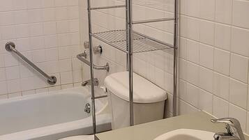A bathroom with a bathtub, toilet, and sink.