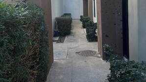 A narrow pathway between buildings with a clear sky above. - SPACIOUS CONDOMINIUM, CLOSE TO AIRPORT (Hermosillo)