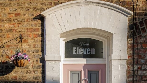 A pink door with a sign above it that reads 'Eleven.' - Stylish Retreat Inside City Walls (York)
