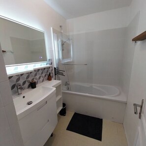 Een haardroger, handdoeken, zeep, toiletpapier