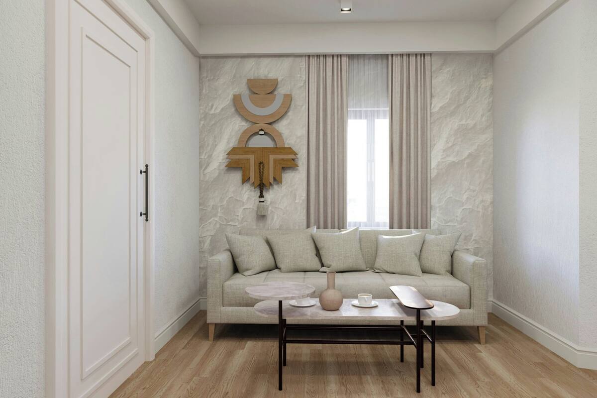 A modern living room with a beige sofa, a coffee table, and a decorative wall piece.