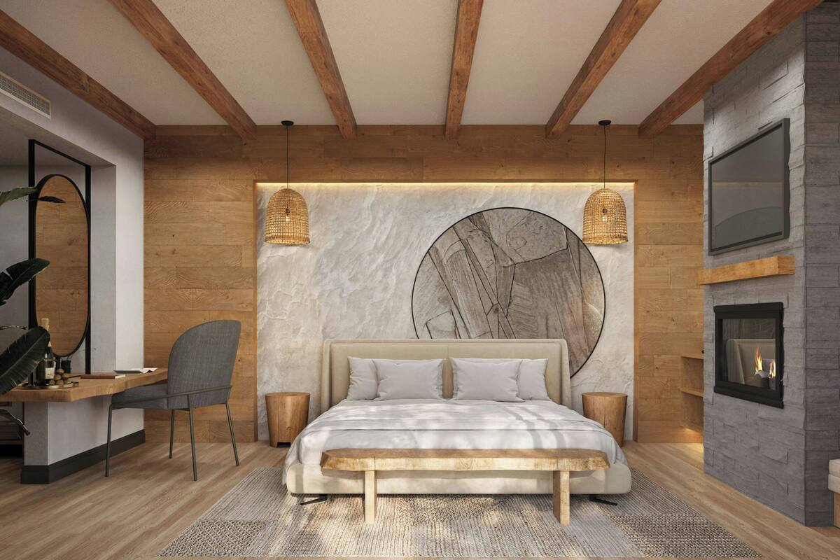 A modern bedroom with a wooden ceiling, a large bed with a marble headboard, a desk with a chair, and a fireplace.