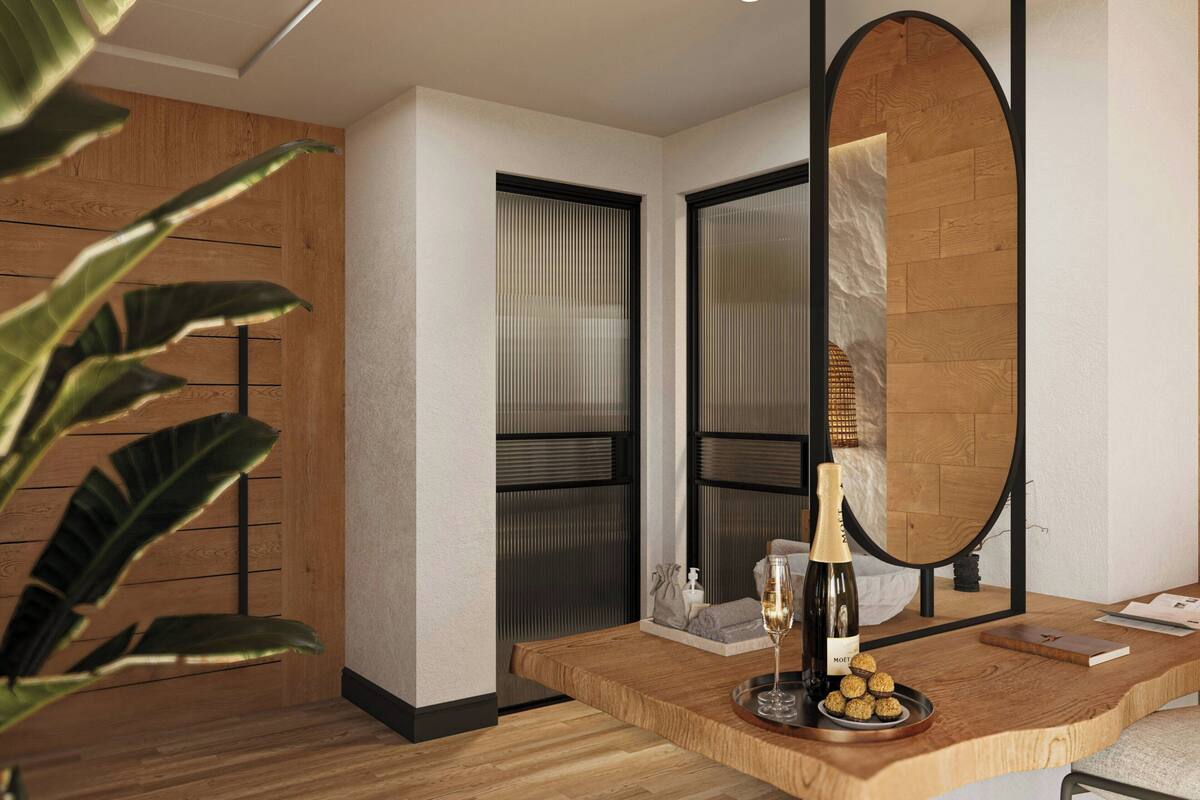 A modern room with a wooden floor, a large mirror, a wooden sideboard, and a plant.