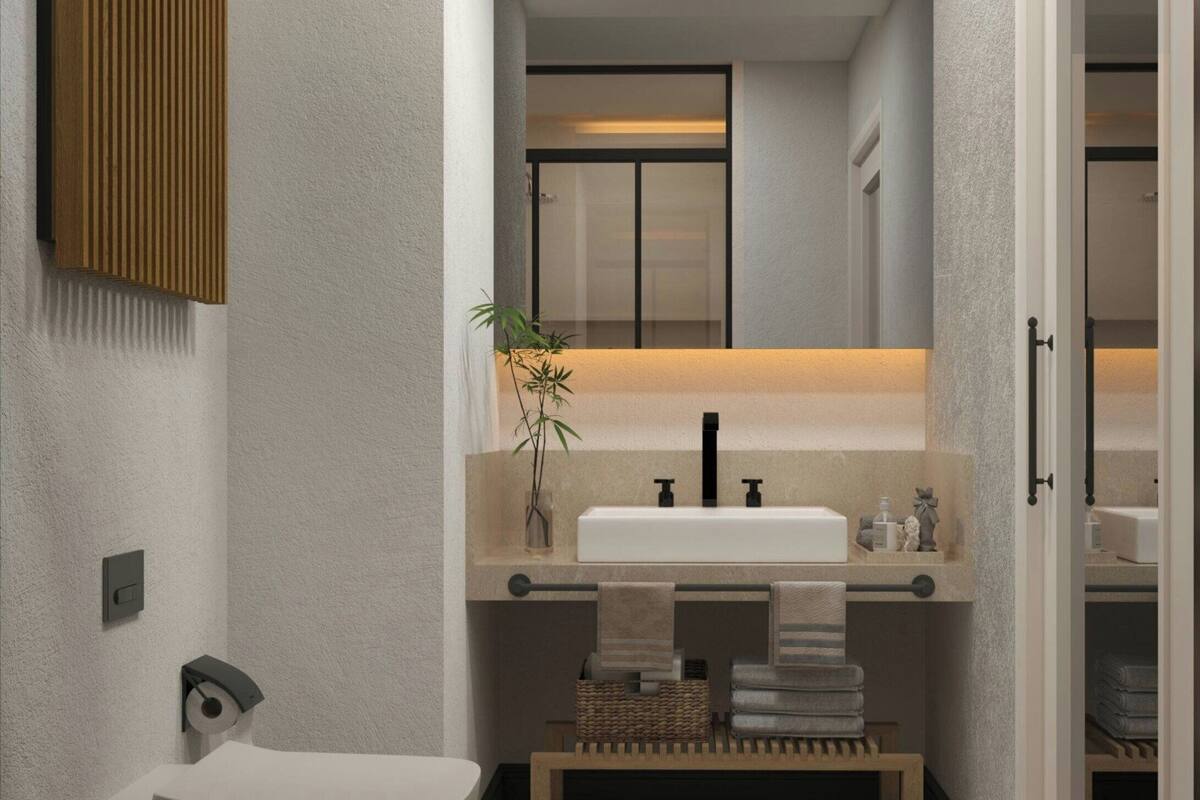 A modern bathroom with a freestanding bathtub, a large mirror, and a sink with a towel rack.
