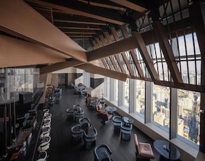 A modern interior with high ceilings, large windows, and a variety of seating arrangements. - The Ritz-Carlton, Wuhan (Wuhan)