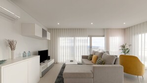 A modern living room with a sofa, a coffee table, and a TV. - Aziadé Horizons - Ocean View (Nazaré)