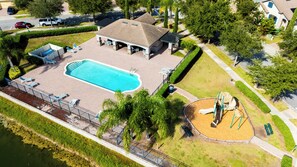 An aerial view of a residential area with a swimming pool, lounge chairs, and a playground. - Comfort & Tranquility • Saint Cloud•Pool•Lake Nona (St. Cloud)