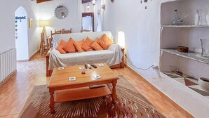 A cozy room with a sofa, a wooden coffee table, and a patterned rug.