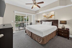 Relax beside a stylish nightstand illuminated by warm lighting for a restful ambiance. - Near Disney! 1BR Deluxe Condo w/ Full Kitchen (Kissimmee)