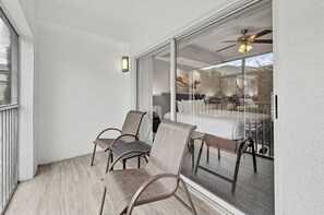 Bright balcony with seating and outside views. - Near Disney! 1BR Deluxe Condo w/ Full Kitchen (Kissimmee)