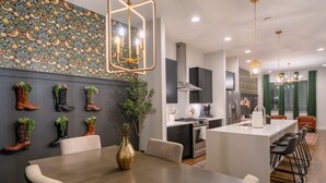 A modern kitchen with a central island, built-in appliances, and a decorative backsplash. - The Bluebell - Music City Views, Game Room, 11 Beds! (Nashville)