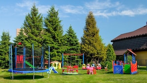 A playground with various play structures including a trampoline, swings, and a climbing frame. - 1 bedroom lovely apartment in Rowy (Rowy)