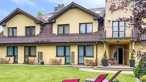 A two-story building with a yellow facade, multiple windows, and a balcony. - 1 bedroom lovely apartment in Rowy (Rowy)