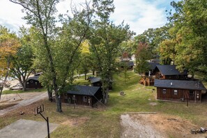 A campground with rustic cabins, a basketball court, and a picnic area. - Hilltop Haven at Sommer Dorf (West Branch)