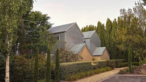 A modern house with a sloped roof and a large garage. - The Retreat at Villa 7 (Hepburn Springs)