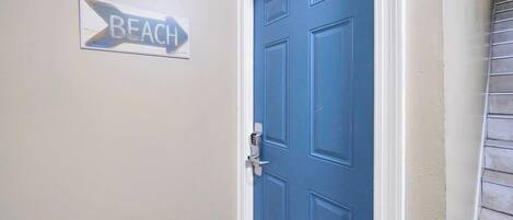 A blue door with a keyhole and a 'B' marking on the wall beside it.
