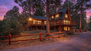 A wooden cabin with a balcony and a staircase, surrounded by trees. - Idyllwild Retreat - Fire Pit, Views, Game Room (Idyllwild-Pine Cove)