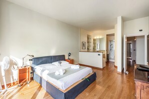 A hotel room with a bed, bedside table, lamp, and a small desk with a chair. - Piazza Rossetti 3A/8, Genova, Italy (Genova)
