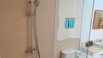 A modern bathroom with a shower, toilet, and sink.