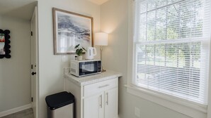 A kitchen with a microwave, a coffee maker, and a potted plant on the counter. - Centrally Located King Bed Midtown Liberty 2695 UP (Memphis)