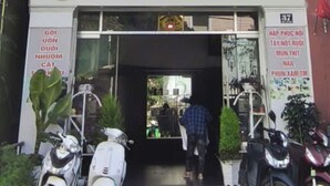 Un immeuble à plusieurs étages, sur lequel on peut lire l’inscription « The Cloud Hotel », et une autre enseigne dans une langue différente. Plusieurs motos sont garées devant.