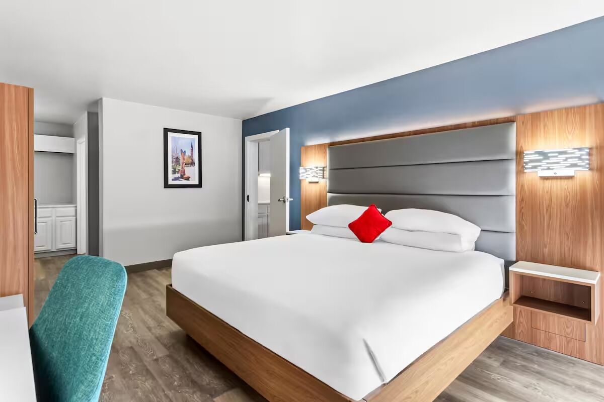 Stretch out on the plush king bed in a modern room.