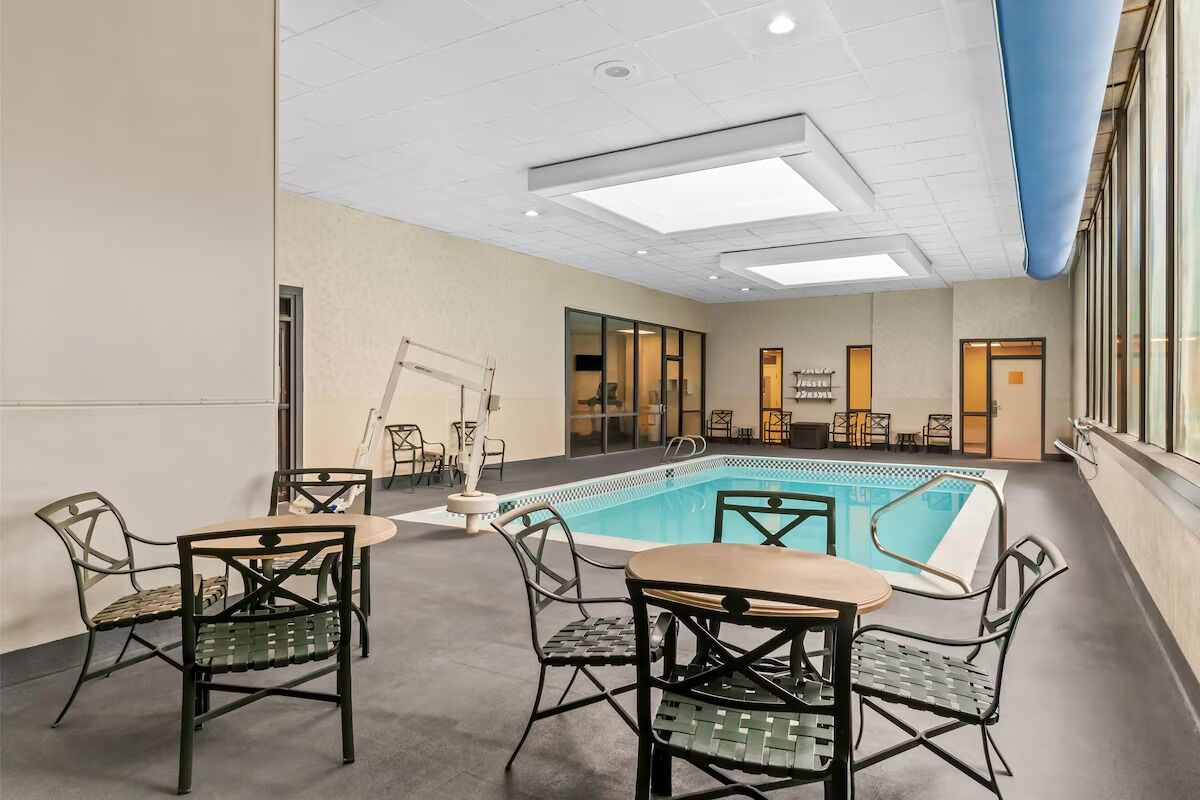 Unwind poolside with cozy seating and warm indoor comfort.
