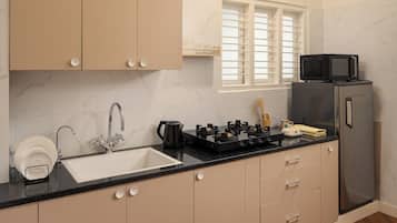 Full-sized fridge, microwave, stovetop, cookware/dishes/utensils