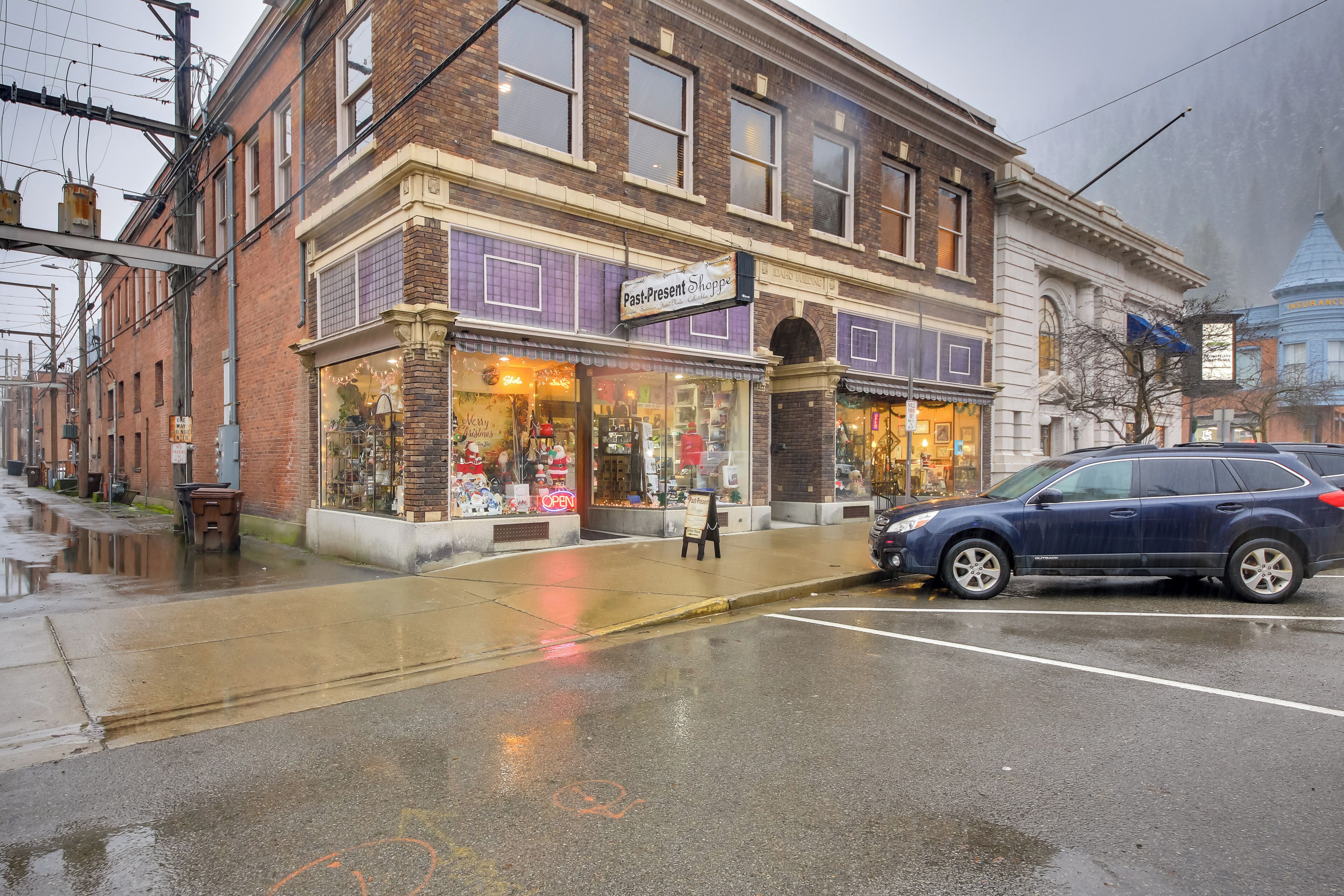 A street view with a building housing 'Past-Present Shops'.