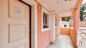 A corridor with a door labeled "1041" and a window with a metal grille. - Cannes Villa Francia - Maeva Home (Cannes)