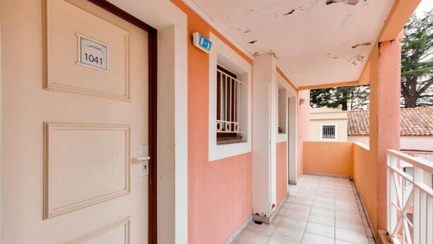 A corridor with a door labeled "1041" and a window with a metal grille. - Cannes Villa Francia - Maeva Home (Cannes)