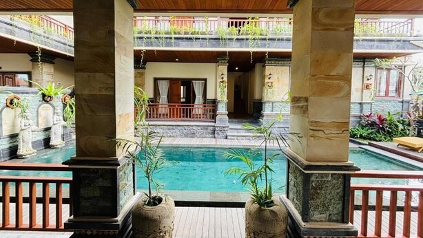 A traditional architectural courtyard with a central pool, stone columns, and a wooden ceiling. - Pondok Wisata Amerta Semaya Agung (Ubud)