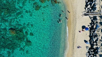 Privatstrand, weißer Sandstrand, Liegestühle, Sonnenschirme