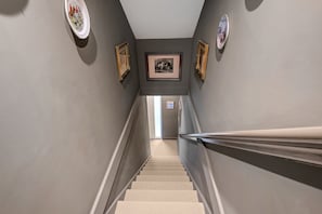 A staircase leading to a room with a framed picture on the wall. - Pools Cottage 1 Game Keepers Eco-Friendly Retreat (Kenilworth)