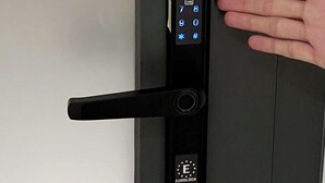 A modern door with a digital keypad lock and a hand approaching to unlock it. - 21 Central Transit Stay | 4 Pax | Near MRT & Bus (Thành phố Hồ Chí Minh)