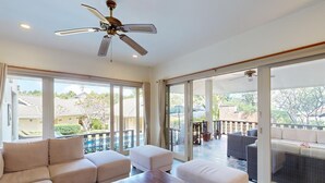 A spacious living area with a sofa set, a wooden coffee table, and a ceiling fan. - Villa mit Blick auf das Wasser by Interhome (Koh Samui)