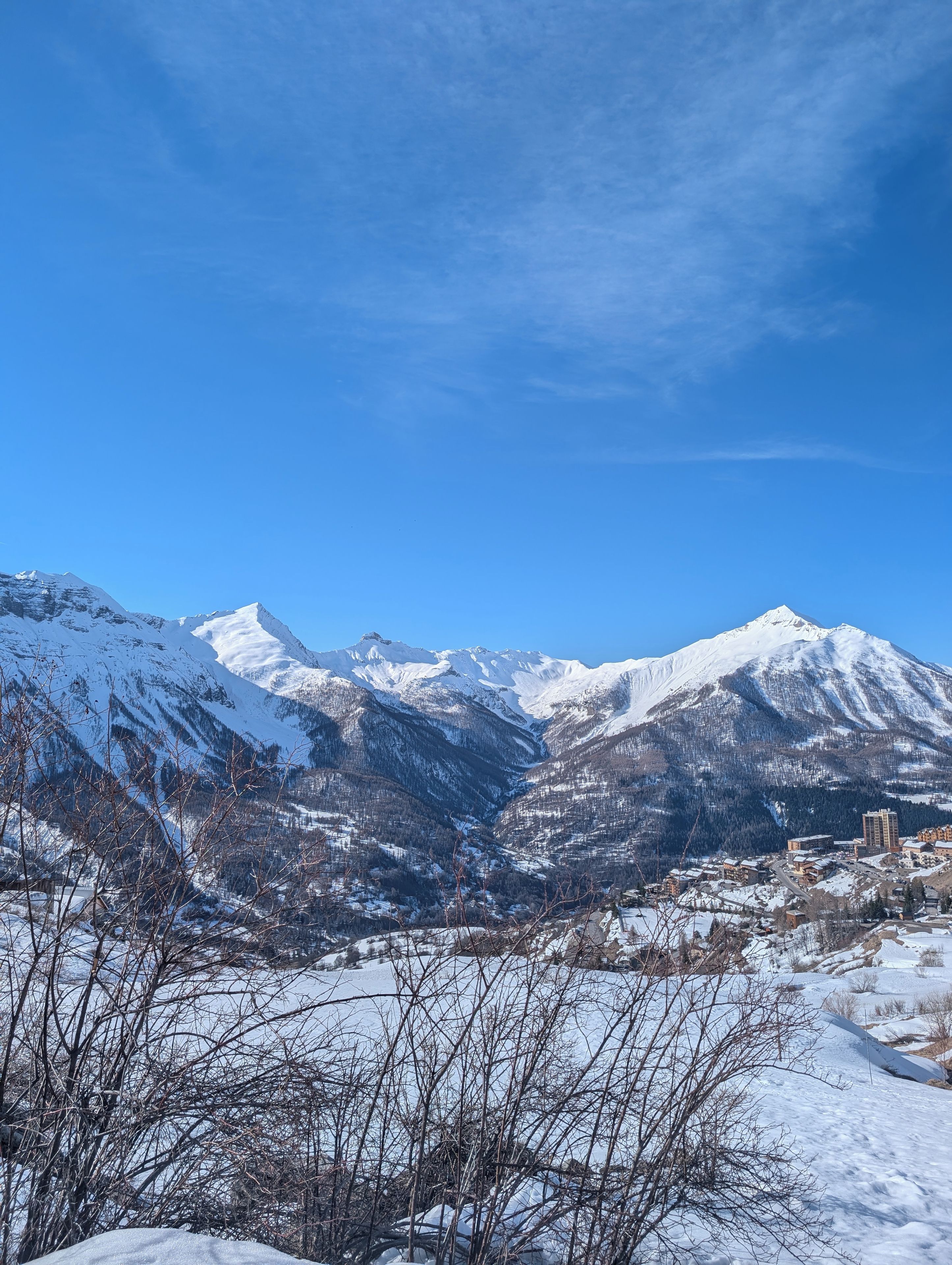A snow-covered mountain range with a clear sky.