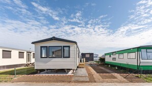 A row of mobile homes with a clear sky.